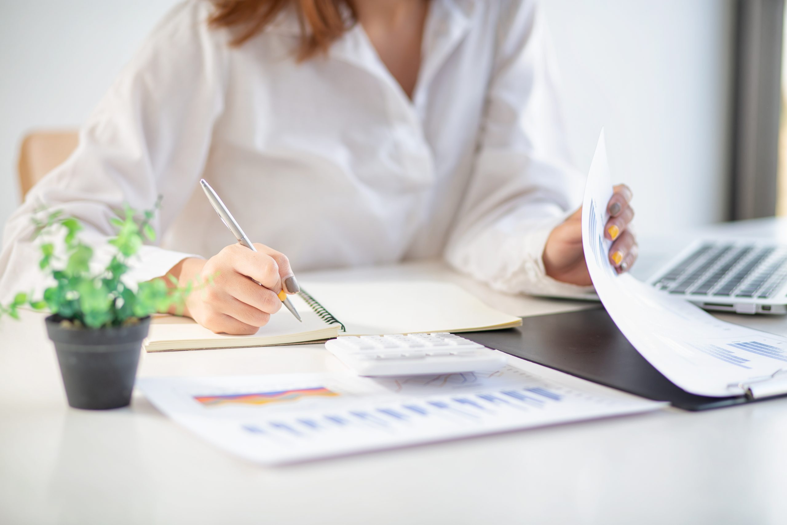 Young businesswoman hands hold documents with financial statisti